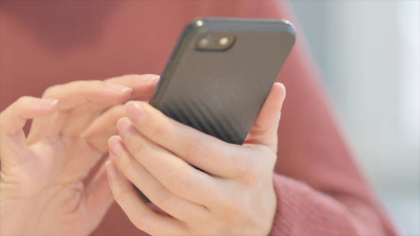 istock Close up of Female Hand Using Smartphone 1465136697