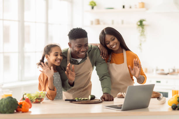 istock African Family Cooking And Video Calling Using Laptop In Kitchen 1465137278