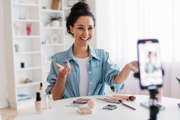 istock Makeup Blogger Lady Talking To Cellphone Making Video At Home 1465137933