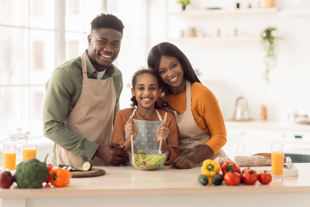 istock Happy Black Parents And Daughter Cooking Hugging In Modern Kitchen 1465138102