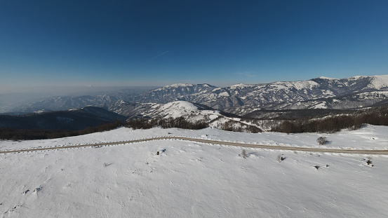 Stara Planina Babin Zub mountain in serbia covered with snow with road in winter day panorama tourist destination and ski center in Serbia road against the mountain peak