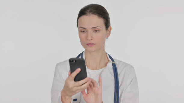 istock Female Doctor Browsing Smartphone on White Background 1465140184