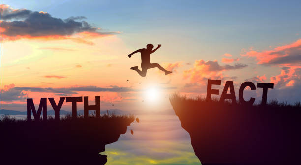 istock Silhouette man jumping from MYTH to FACT with sunrise. Fact and Myth Concept. 1465140254