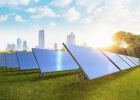 3d rendering solar panel farm on green field with cityscape background