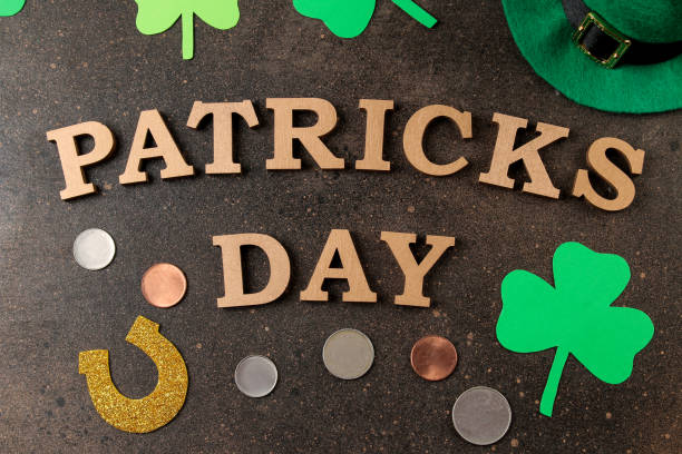 istock St.Patrick 's Day. celebration. Green leprechaun hat, money, bow tie and clover leaf on a brown background. view from above. 1465145863