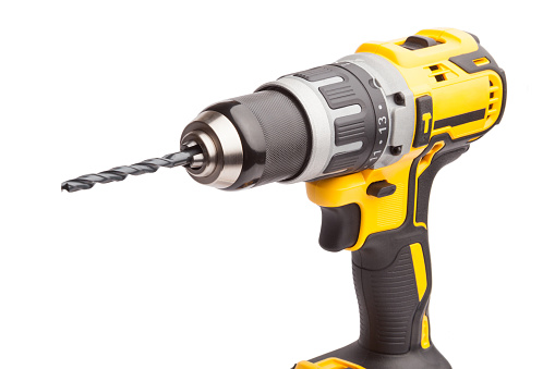 Cordless electric drill with a drill bit in white background