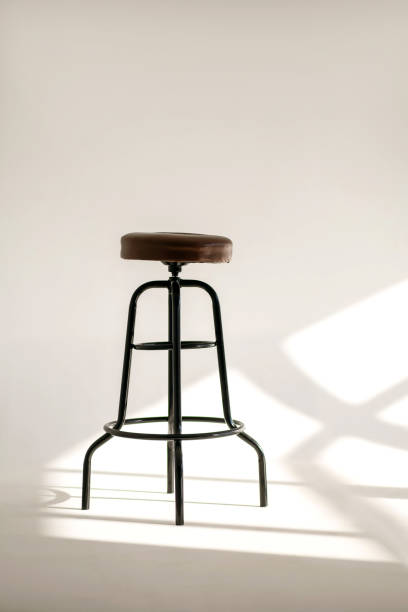 istock A white room with a shade from the sun through the window and one high bar stool 1465148201