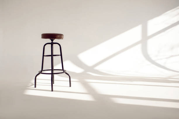 istock A white room with a shade from the sun through the window and one high bar stool 1465148202