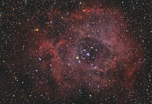 The Rosette Nebula located near one end of a giant molecular cloud in the Monoceros region of the Milky Way. Stars night sky backgrounds with 80mm refractor telescope