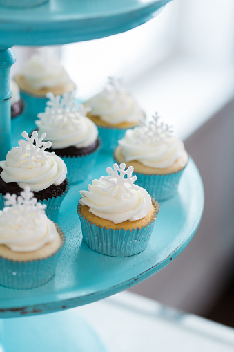 Holiday cupcakes on a blue cake stand