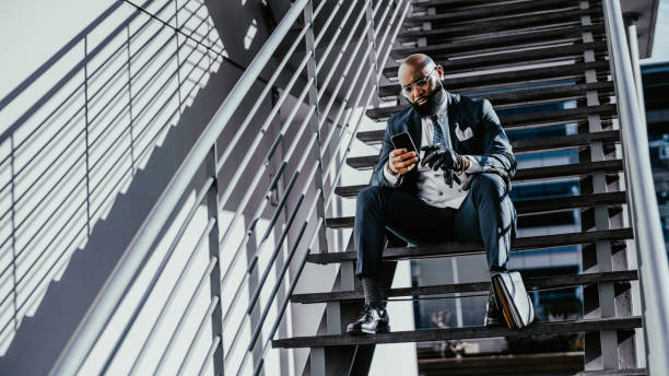 istock A black man phoning on a staircase 1465159282