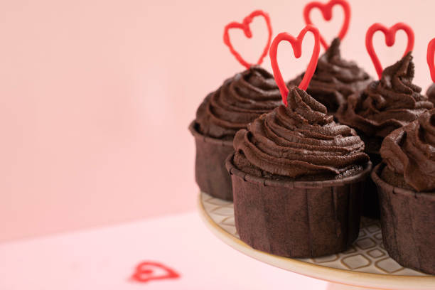 istock Chocolate cupcakes with ganache frosting and a heart-shaped chocolate 1465162912