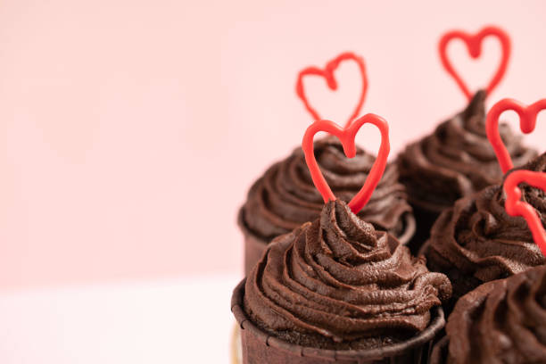istock Chocolate cupcakes with ganache frosting and a heart-shaped chocolate 1465162940