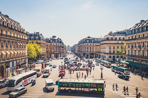 Paris, France - Apr 19, 2019 - Busy square in the central part of the city with buses, cars and people