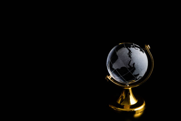 Miniature symbolic crystal globe on a black background
