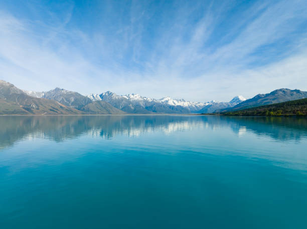 istock Blue lake with mountains in background. 1465172538