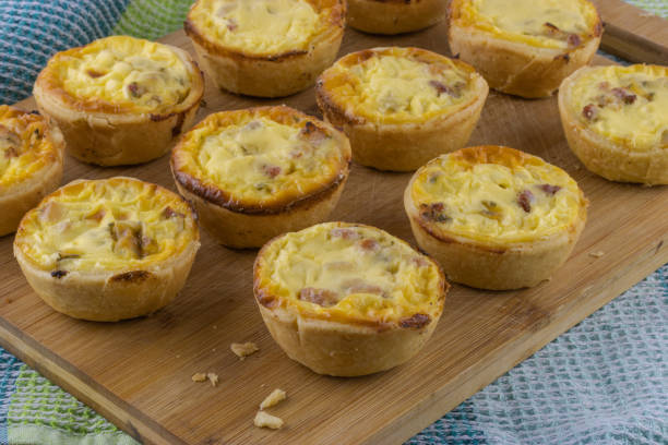 istock Home made mini ham and cheese quiches on wooden board 1465173735