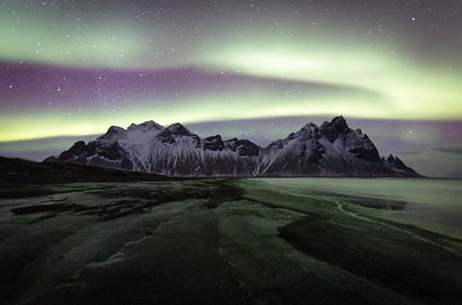Aurora borealis over the spectacular Vesterhorn mountains in South-Eastern Iceland