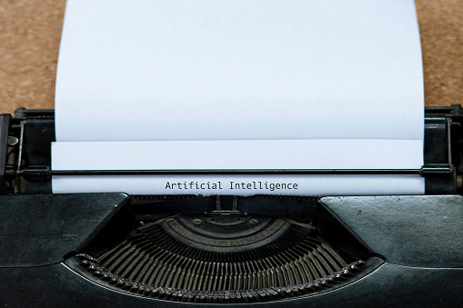 Artificial Intelligence word typed on traditional typewriter over white paper