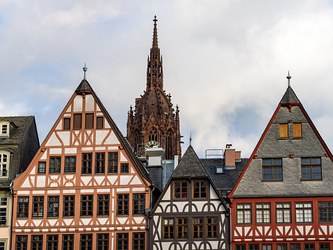 Frankfurt, Old town architecture in the city centre. The cathedral Kaiserdom is behind the half-timbered buildings. Traditional facades are part of the exterior.