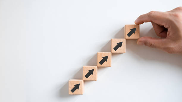 istock Business growth concept, male hands arranged stacked wooden blocks steps on white table, future business growth arrow, development to achieve goals, copy space. 1465187818