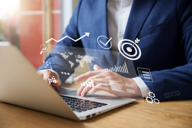 istock Businessman analyzing company's financial balance sheet working with digital augmented reality graphics. Businessman calculates financial data for long-term investment. 1465189516