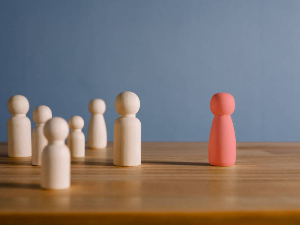 istock selecting different personnel The red wooden man stood out from the crowd. 1465190921