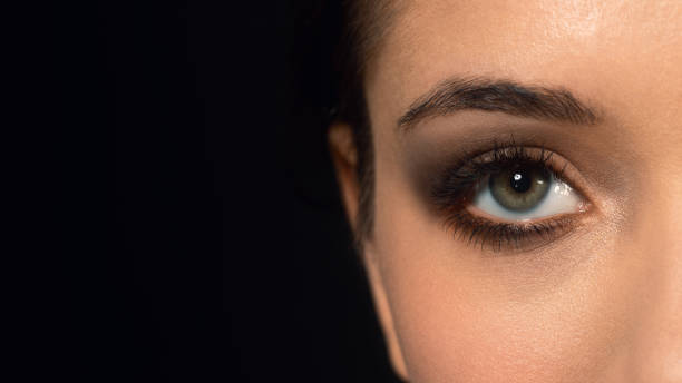 istock Beautiful female eye on black background, macro, close up. 1465192747
