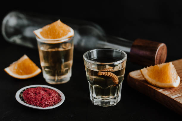 Mexican Mezcal Shots with worm, orange slice and spicy Salt in Mexico Latin America Mexican Mezcal Shots with worm, orange slice and spicy Salt in Mexico Latin America tequila sunrise stock pictures, royalty-free photos & images