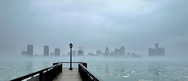 The Detroit skyline (enveloped in fog) as seen from across the Detroit River, in Windsor, Ontario, Canada.