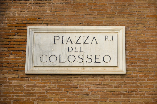 Traditional, Italian street sign carved in marble.  Piazza Del Colosseo in Rome, Italy