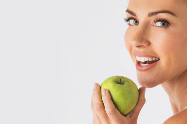 istock Woman holding green apple 1465217034