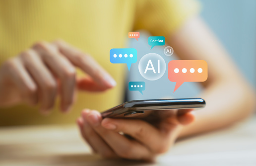 Hand using smartphone and chatting with chatbot application, shows message speech bubbles digital screen of social media notifications. Ai (Artificial Intelligence) technology concept.