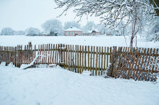 istock Old wooden rural fence under snow 1465219010