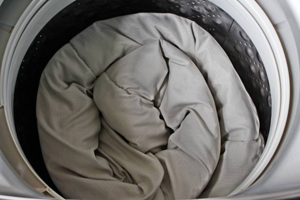 istock Roll up the duvet and put it in the washing machine. 1465220641