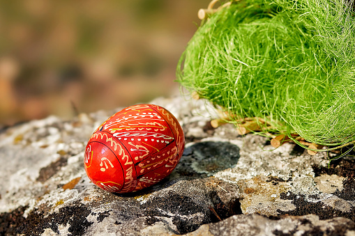 Colorful Easter egg in the forest