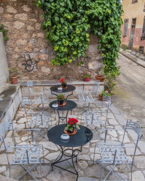 Outdoor tables in a courtyard A small courtyard with three cafe style tables koper slovenia stock pictures, royalty-free photos & images
