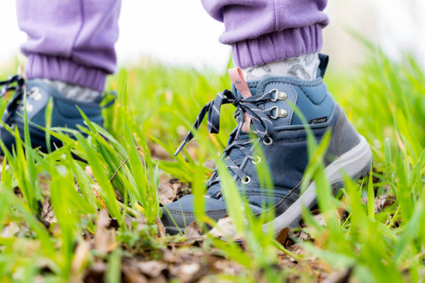 istock Selective focus of a hiker's shoes on a grassy field 1465222843