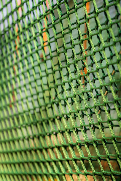 istock Vertical shot of a green net fence 1465223222