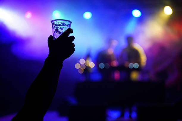 istock Hand silhouette holding a cup during festival at night 1465223417