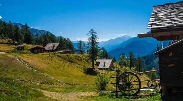 A closeup shot of country-style buildings and a wheel in the valley of Aosta in Italy