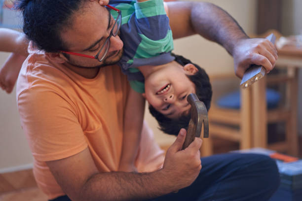 istock Hispanic father assembles wooden furniture while his son hangs by his neck in Chile 1465228111