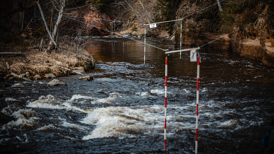 A closeup shot of the gate of whitewater slalom over the rough river