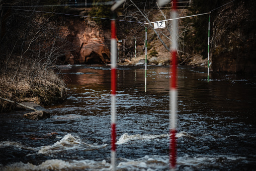A closeup shot of the gate of whitewater slalom over the rough river
