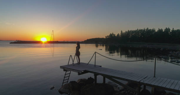 istock Woman standing on a wharf 01 1465228680