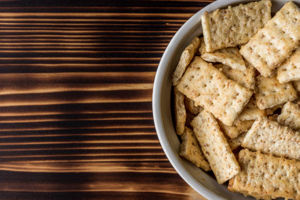 istock Top view of rectangular crackers in the bowl on the wooden table with copy space 1465228685