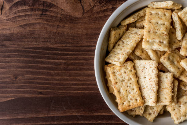 istock Top view of rectangular crackers in the bowl on the wooden table with copy space 1465228716