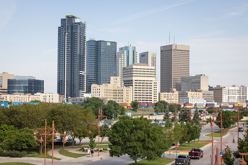 Winnipeg, Canada – August 31, 2022: The skyline of downtown Winnipeg as seen from The Forks in Winnipeg, Manitoba, Canada.