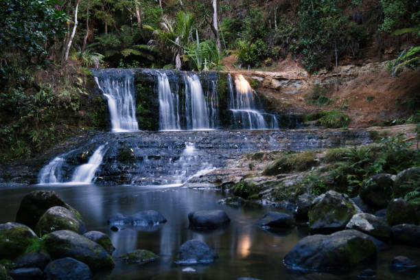 istock Beautiful view of a small waterfall with a pool in the forest background 1465231957