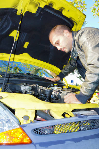 istock Vertical shot of a man looking at the car engine to fix it 1465232051